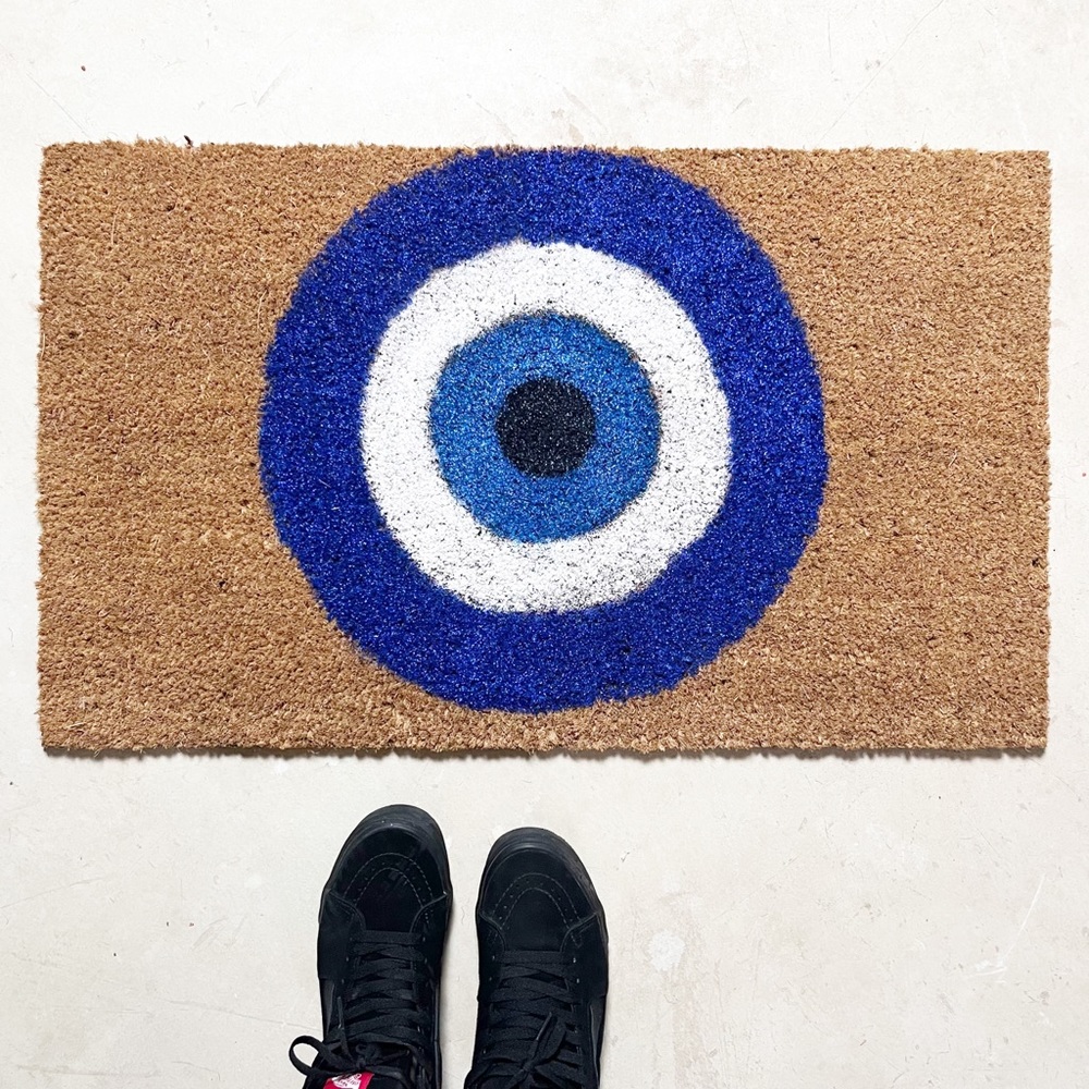 Evil eye glittered doormat.